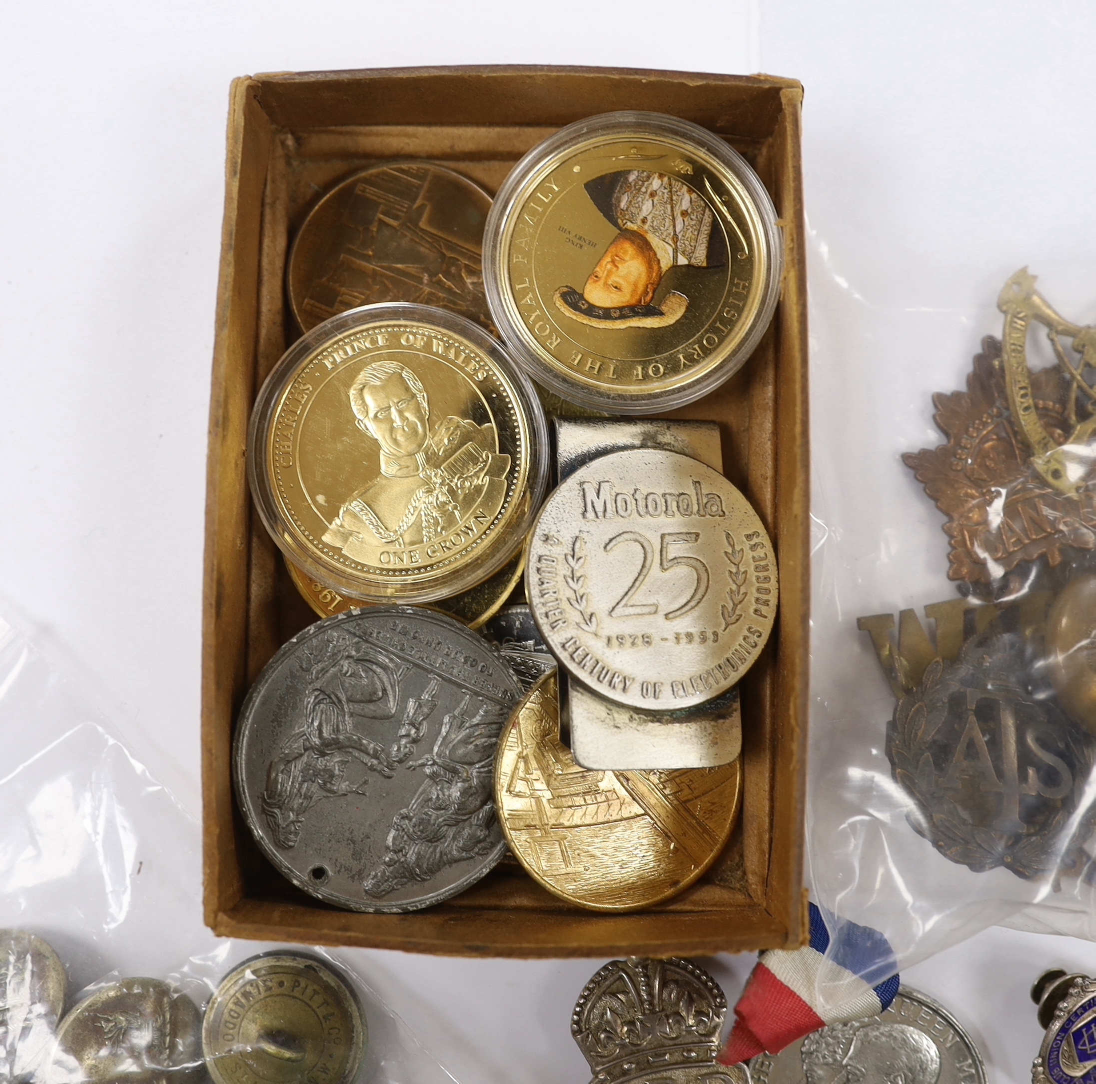 A collection of medals, cap badges, commemorative coins etc. including; a cased RMS Lusitania medal, Royal Artillery sweetheart brooches, a miniature WWII medal group of three stars; the 1939-45 Star, the Atlantic Star a